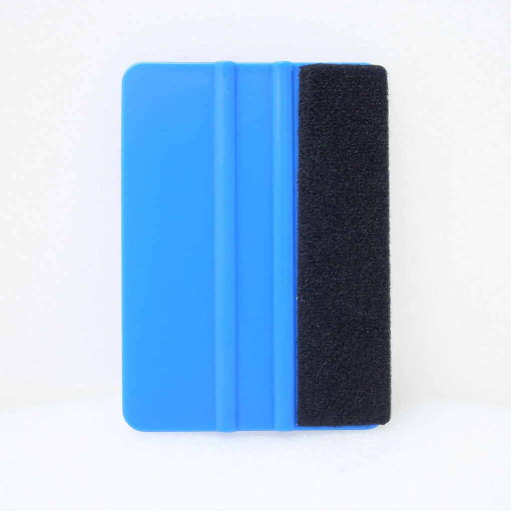A rectangular squeegee tool with a bright blue plastic body and a black textured rubber or foam side, shown against a plain white background.