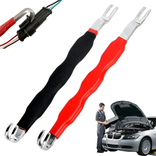 Two car jump starter cables with a person working on a car in the background.