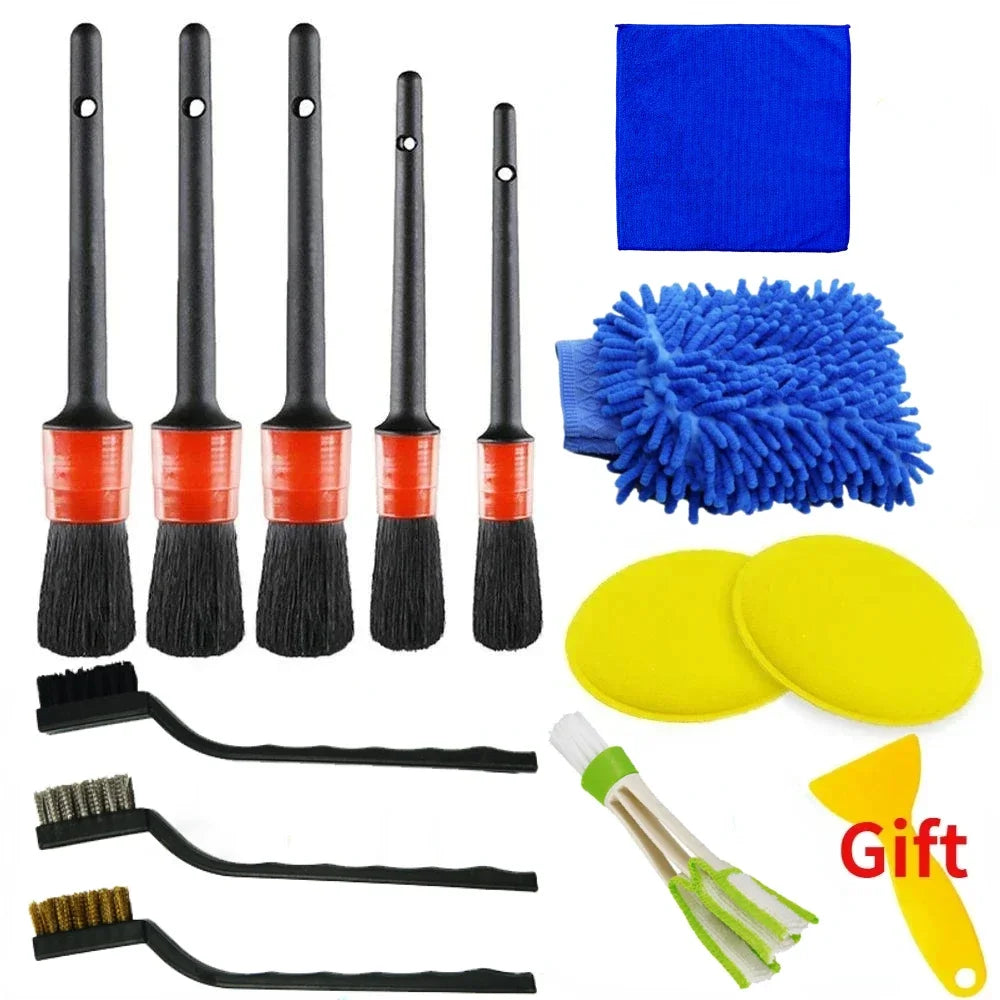 Set of car cleaning tools including brushes and cloths on a white background